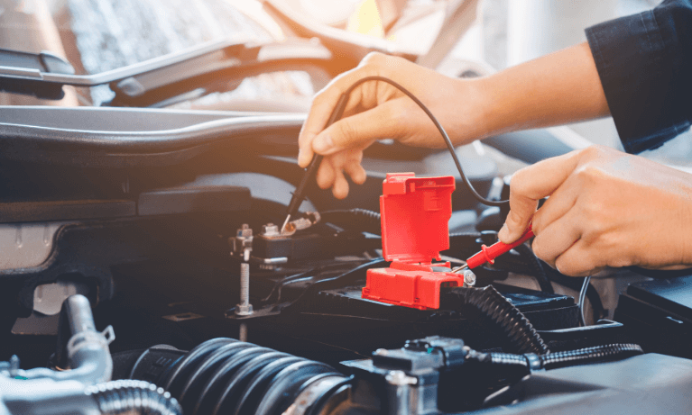 a person performing a test on their car battery